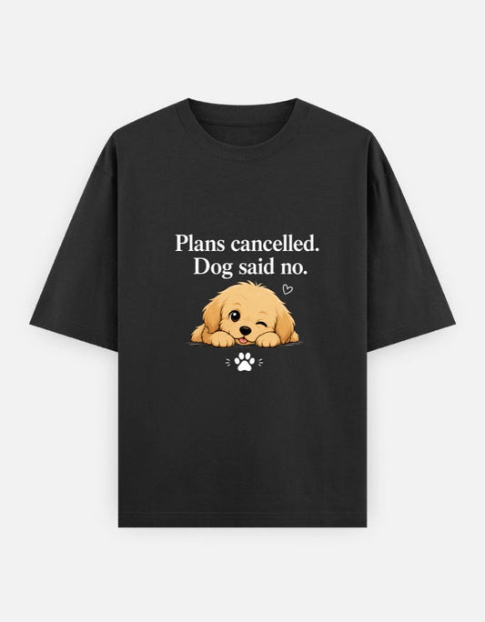 Unisex oversized black T-shirt with "Plans Cancelled. Dog said no." design by The Unserious Studio, featuring a playful dog graphic.