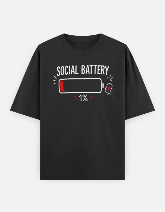 Unisex oversized tee from The Unserious Studio featuring a front graphic with "Social Battery 1%" in bold black text.