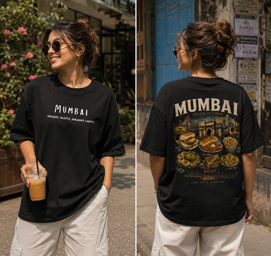 A woman modeling a black oversized T-shirt in a split front-and-back view. The front shows the word 'MUMBAI' in white, and the back features a large multicolor graphic with the word 'MUMBAI' above food illustrations.