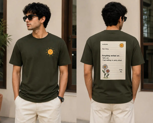 A man modeling an olive green t-shirt, shown from both the front and back. The front features a small yellow smiley face sun graphic on the left chest.