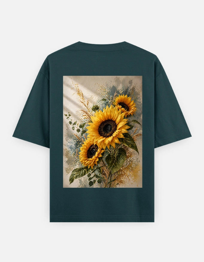 Back view of The Unserious Studio oversized unisex tee with "Heal. Bloom. Glow" graphic in soft pastel colors.