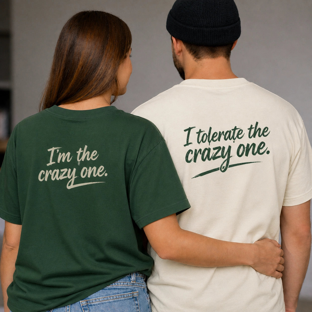 Two oversized unisex couple T-shirts by The Unserious Studio, with humorous "I Tolerate the Crazy One" and "I am the Crazy One" designs.