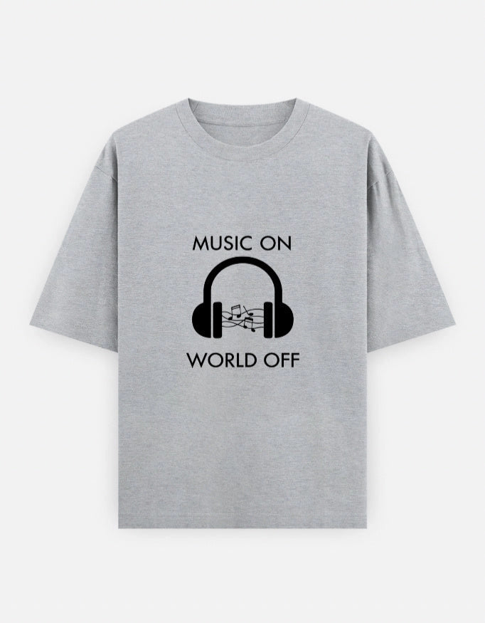 Front view of The Unserious Studio oversized unisex T-shirt with "Music on, World Off" graphic in black on white cotton fabric.