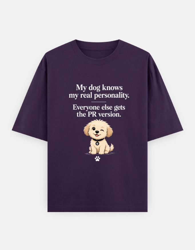 Unisex oversized T-shirt by The Unserious Studio featuring a front graphic with the text "My Dog Knows My Real Personality" in bold lettering.