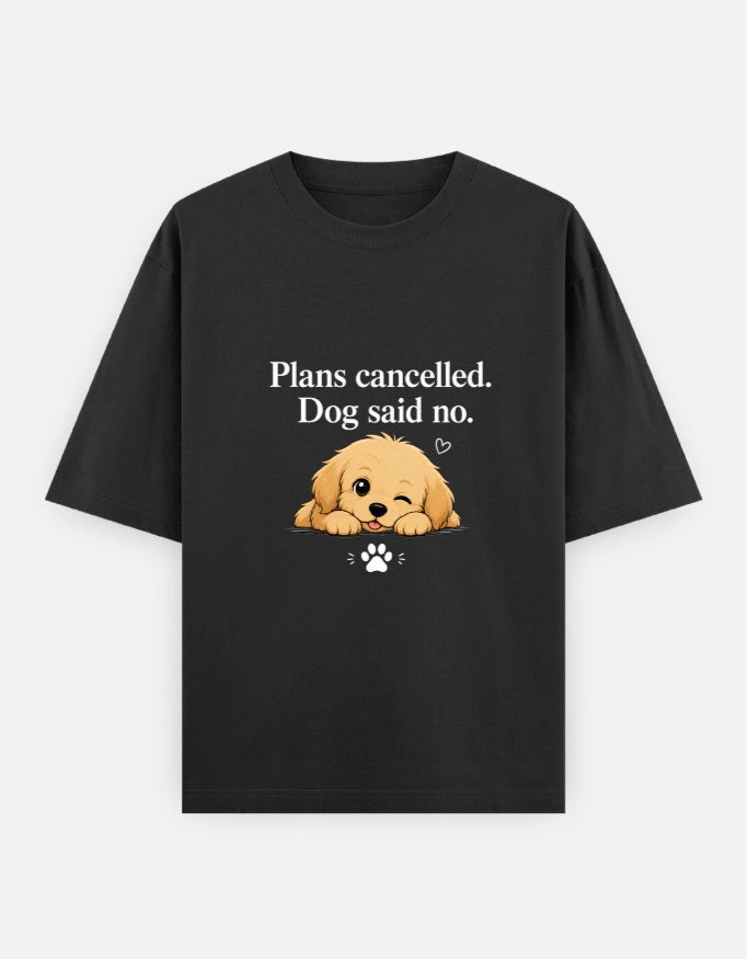 Unisex oversized black T-shirt with "Plans Cancelled. Dog said no." design by The Unserious Studio, featuring a playful dog graphic.
