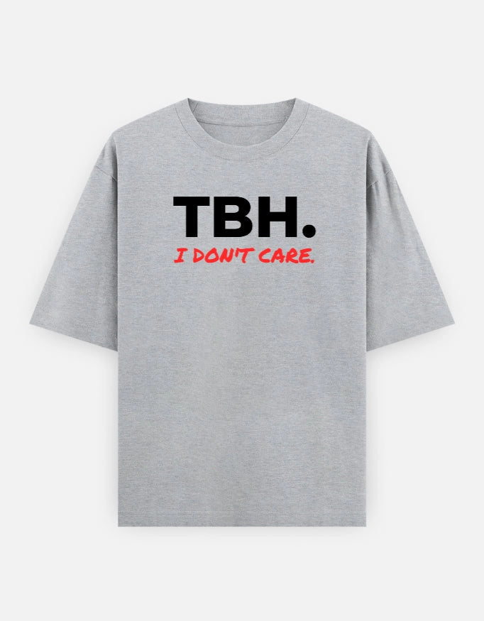 Front view of The Unserious Studio oversized unisex T-shirt with "TBH Unbothered" slogan in black on a white fabric.